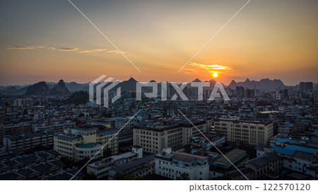 A sunset aerial view of Guilin city with karst mountains in the back. China 122570120