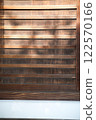Scenery of old wooden shutters with sunlight shining on them 122570166