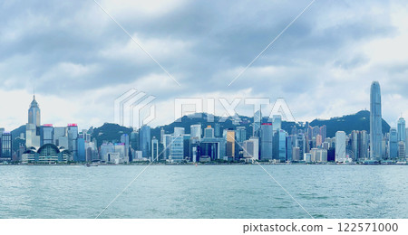 從維多利亞港俯瞰香港白天的摩天大樓和山脈全景照片 122571000