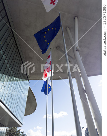 Waving flag of Georgia and flag of European Union 122571096