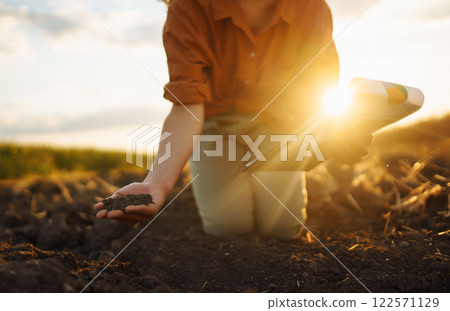 Female hands touching soil on the field. Agriculture, gardening or ecology concept Female hands touching soil on the field. Agriculture, gardening or ecology concept 122571129