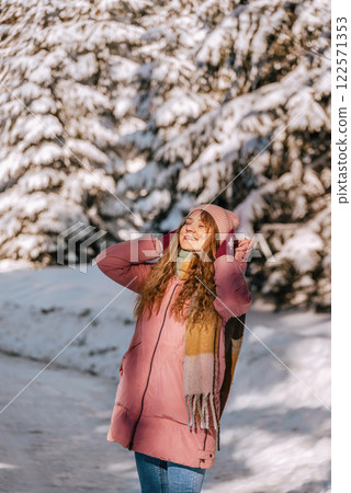 Happy Woman Enjoying Walk in Winter Forest 122571353