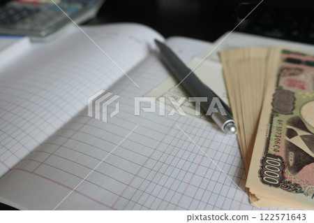 Household account book and new banknotes 122571643