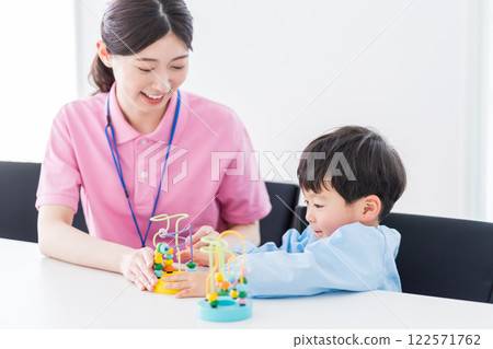 Nursery school children and nursery teachers training with educational toys 122571762