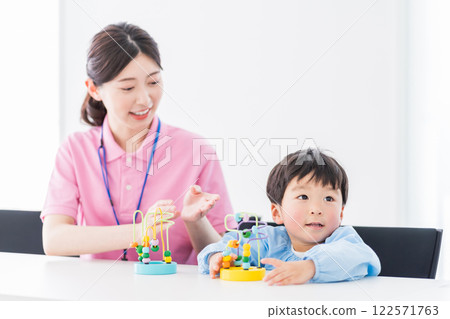 Nursery school children and nursery teachers training with educational toys 122571763