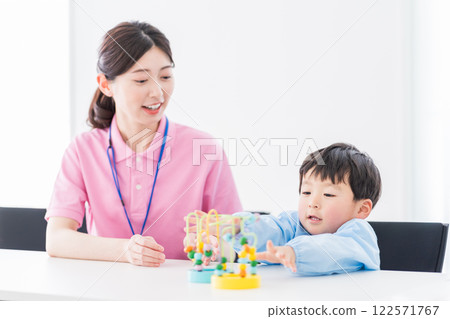 Nursery school children and nursery teachers training with educational toys 122571767