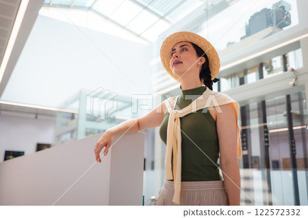 Bottom view of Caucasian elegant young pretty woman in a straw hat. Concept of business Bottom view of Caucasian elegant young pretty woman in a straw hat. Concept of business 122572332
