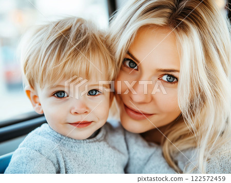 Happy mother with her young son sitting together on a bus, both smiling 122572459