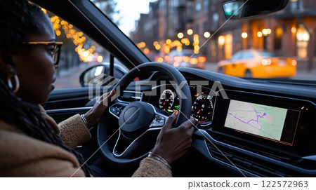 Driving at night with navigation on, showcasing city lights and focus 122572963