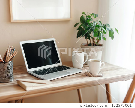 Cozy workspace with a laptop, two white mugs, a potted plant Cozy workspace with a laptop, two white mugs, a potted plant 122573001
