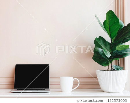 Minimalist desk setup with a sleek laptop Minimalist desk setup with a sleek laptop 122573003