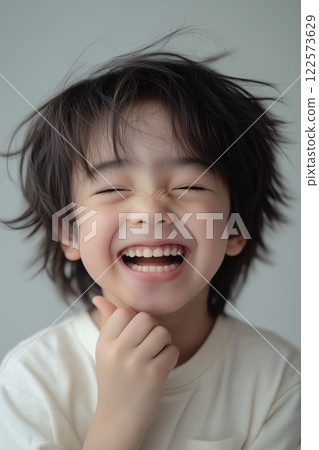 Joyful boy laughing brightly, boy radiating emotion of happiness and delight, emotion reflecting carefree innocence, capturing lively energy and cheerful moments in dynamic and uplifting storytelling 122573629
