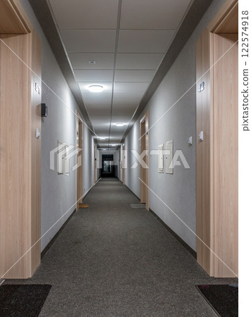 Modern Hallway Interior with Doors and Carpeted Floor Modern Hallway Interior with Doors and Carpeted Floor 122574918