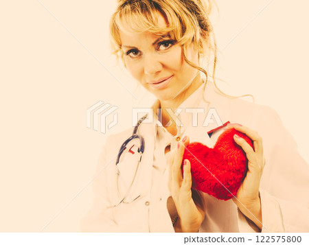 Female cardiologist with red heart. Female cardiologist with red heart. 122575800