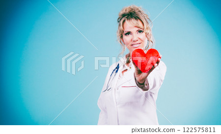 Middle aged blonde doctor enjoy her work. Middle aged blonde doctor enjoy her work. 122575811