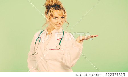 Female doctor showing copy space. Female doctor showing copy space. 122575815
