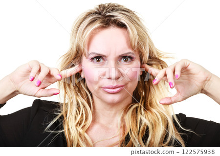 Blonde woman plug ears 122575938