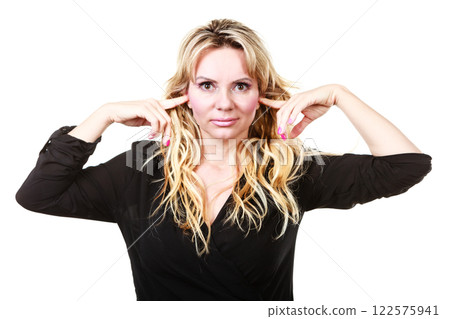 Blonde woman plug ears Blonde woman plug ears 122575941