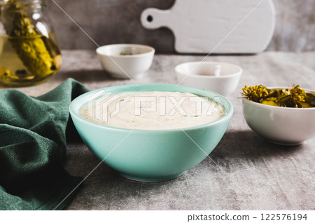 Traditional ranch dressing made with cottage cheese and pickles in a bowl on the table 122576194