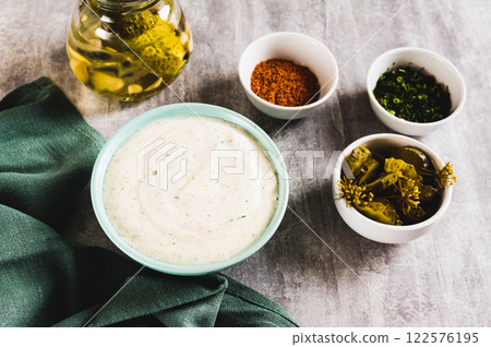 Spicy sour cream sauce with garlic in a bowl on the table 122576195