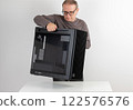 Man holding a heavy PC case, weight 15,8 kg, empty big tower, chassis. 122576576