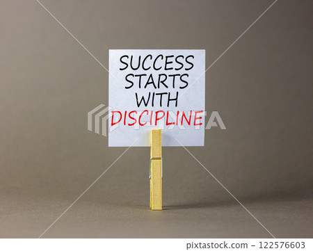 Success starts with discipline symbol. Concept words Success starts with discipline on beautiful white paper. Beautiful grey background. Business success starts with discipline concept. Copy space Success starts with discipline symbol. Concept words Success starts with discipline on beautiful white paper. Beautiful grey background. Business success starts with discipline concept. Copy space 122576603