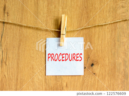 Procedures symbol. Concept word Procedures on beautiful white paper on clothespin. Beautiful wooden background. Business procedures concept. Copy space. Procedures symbol. Concept word Procedures on beautiful white paper on clothespin. Beautiful wooden background. Business procedures concept. Copy space. 122576609