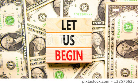 Let us begin symbol. Concept words Let us begin on beautiful wooden blocks. Dollar bills. Beautiful background from dollar bills. Business motivational let us begin concept. Copy space. 122576623