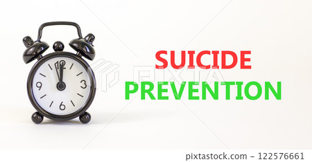Suicide prevention symbol. Concept words Suicide prevention on beautiful white paper. Black alarm clock. Beautiful white paper background. Psychological and suicide prevention concept. Copy space. 122576661