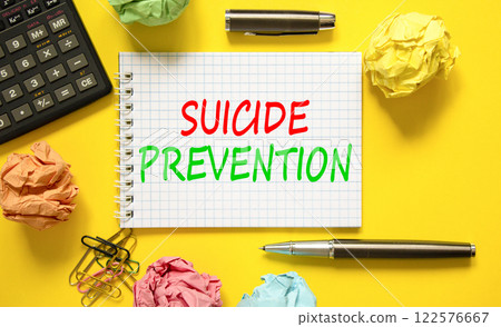 Suicide prevention symbol. Concept words Suicide prevention on beautiful white note. Black calculator. Colored paper. Beautiful yellow background. Psychological suicide prevention concept. Copy space 122576667