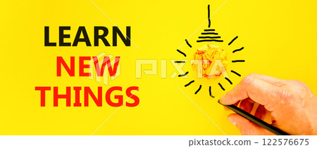 Learn new things symbol. Concept words Learn new things on beautiful yellow paper. Beautiful yellow background. Businessman hand. Light bulb. Business motivational learn new things concept. Copy space 122576675
