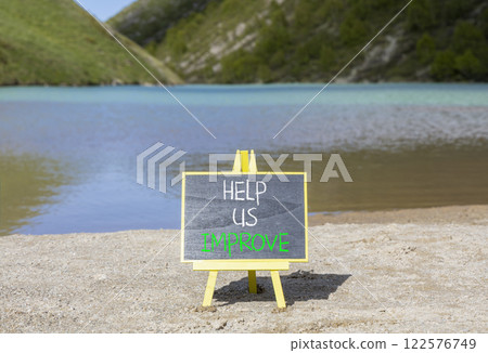 Help us improve symbol. Concept words Help us improve on beautiful black yellow blackboard. Beautiful mountain lake background. Business motivational help us improve concept. Copy space. 122576749