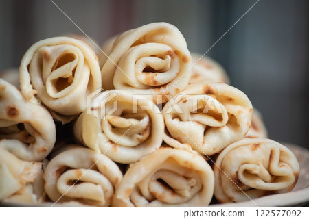 Stack of rolled crepes served on a plate 122577092