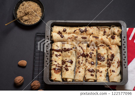 Delicious Chocolate Drizzled Crepe on Black Tray Delicious Chocolate Drizzled Crepe on Black Tray 122577096