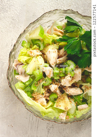 Waldorf salad, celery salad with apple, in a glass salad bowl, natural light, homemade, no people, 122577141