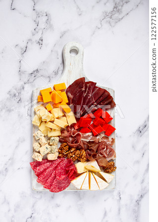 assortment of cheese meat cuts, on a plate, top view, no people, 122577156