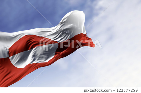 The flag of Greenland waving in the wind on a clear day. The flag of Greenland waving in the wind on a clear day. 122577259