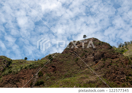 Mountain and a blue sky with clouds, Madeira, Portugal Mountain and a blue sky with clouds, Madeira, Portugal 122577345
