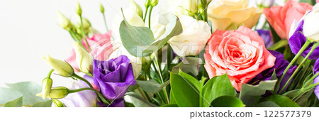 This seasonal bouquet of roses, eucalyptus, and eustoma in soft pink, white, and purple tones makes an ideal gift for anniversaries, birthdays, or any special event, banner 122577379