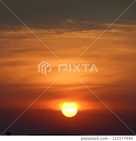 Bright sun against the background of red clouds. Bright sun against the background of red clouds. 122577444