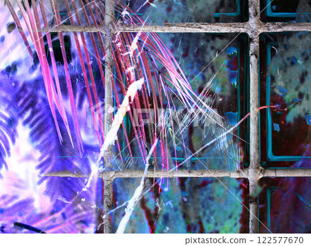 Abstract shapes and lines Purple wallpaper. Tropical leaves, palm leaf in neon pink purple shades behind a tiled glass wall. Scratch scuffed texture. Abstract shapes and lines Purple wallpaper. Tropical leaves, palm leaf in neon pink purple shades behind a tiled glass wall. Scratch scuffed texture. 122577670