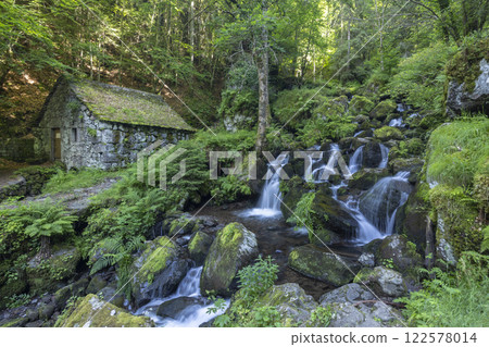 Water wheel mill (Moulin de Chambeuil) with waterfalls, Laveissiere, Cantal, Auvergne-Rhone-Alpes, France 122578014