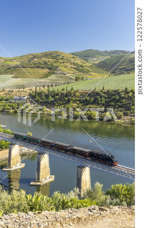 Steam train on railway bridge (Ponte Ferroviaria do Tua), Tua, Alto Douro, Portugal Steam train on railway bridge (Ponte Ferroviaria do Tua), Tua, Alto Douro, Portugal 122578027