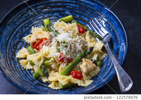 Farfalle pasta with green asparagus, cherry tomatoes and chicken Farfalle pasta with green asparagus, cherry tomatoes and chicken 122578076