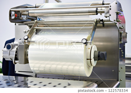 Roll of packaging film on machine food factory 122578334