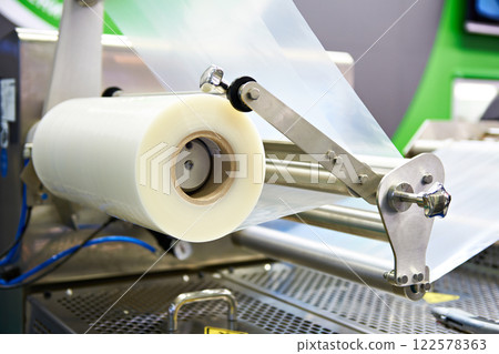 Roll of packaging film on machine food factory 122578363