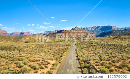Aerial of Desert Road and Majestic Mountains in Utah Aerial of Desert Road and Majestic Mountains in Utah 122579092
