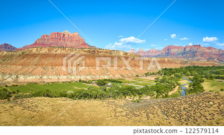 Aerial of Red Rock Formations and Green Valley in Grafton Utah 122579114