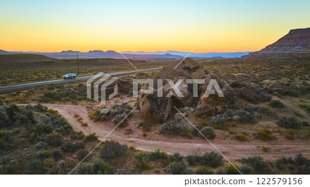 Aerial of Rugged Desert Landscape with Car at Sunset Aerial of Rugged Desert Landscape with Car at Sunset 122579156