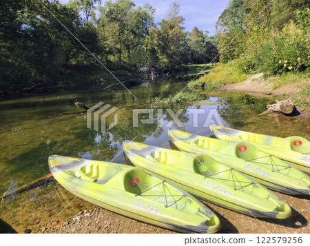 Serene Riverside Kayaks Ready for Adventure at Eye Level Serene Riverside Kayaks Ready for Adventure at Eye Level 122579256